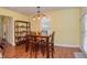 Cozy dining area with wooden table and chairs, enhanced by natural light from the window at 115 Northshore Blvd, Anderson, IN 46011