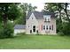 Inviting two-story home with red shutters, front patio and well maintained lawn at 115 Northshore Blvd, Anderson, IN 46011