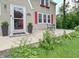 Inviting front porch with flower boxes and small bistro set at 115 Northshore Blvd, Anderson, IN 46011