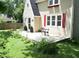 Charming front porch with bistro set and well landscaped lawn at 115 Northshore Blvd, Anderson, IN 46011