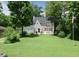 Beautiful two-story home with a large front lawn and mature trees at 115 Northshore Blvd, Anderson, IN 46011