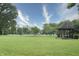Well-manicured lawn with gazebo and mature trees at 115 Northshore Blvd, Anderson, IN 46011