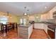 Bright kitchen with an island, stainless steel appliances, and adjacent dining area at 115 Northshore Blvd, Anderson, IN 46011