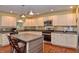 The kitchen boasts stainless appliances, a center island, and ample cabinet space at 115 Northshore Blvd, Anderson, IN 46011