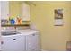 Laundry room with a washer, dryer, storage cabinets, and a bright, clean appearance at 115 Northshore Blvd, Anderson, IN 46011
