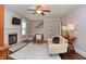 Well-lit living room with fireplace, hardwood floors, ceiling fan, and neutral paint at 115 Northshore Blvd, Anderson, IN 46011