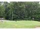 Community putting green with mature trees and landscaped grounds at 115 Northshore Blvd, Anderson, IN 46011