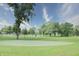 Community putting green with mature trees and landscaped grounds at 115 Northshore Blvd, Anderson, IN 46011