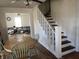 Dining room with table and chairs, open to the living room and staircase at 118 S Swain St, Ingalls, IN 46048