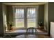 Close-up on a large, bright window in the dining room featuring plants on either side at 118 S Swain St, Ingalls, IN 46048