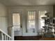 Bright entryway with windows, staircase, and space for a cat tree or other decor at 118 S Swain St, Ingalls, IN 46048
