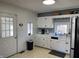 Functional kitchen with white cabinets and neutral countertops, offering plenty of space at 118 S Swain St, Ingalls, IN 46048