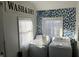 Laundry room with side-by-side washer and dryer, great storage, and a pop of wallpaper at 118 S Swain St, Ingalls, IN 46048