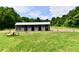 View of the horse barn featuring metal siding, four stalls, and a tractor in front at 1284 N Letterman Rd, Paragon, IN 46166