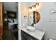 A view into a modern bathroom featuring a unique vessel sink, granite countertop, and wood-look floors at 1284 N Letterman Rd, Paragon, IN 46166