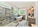 Bright bathroom featuring a standalone tub, glass shower, and large windows at 1284 N Letterman Rd, Paragon, IN 46166