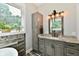 Bathroom with stylish gray cabinets, granite countertop, and a garden view window at 1284 N Letterman Rd, Paragon, IN 46166