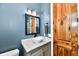 A modern bathroom vanity with a new sink, new paint, and attractive mirror at 1284 N Letterman Rd, Paragon, IN 46166