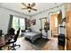 Nicely decorated bedroom featuring updated ceiling fan, decorative garlands, and an ensuite bathroom at 1284 N Letterman Rd, Paragon, IN 46166