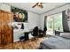 Bedroom with a ceiling fan, wood-look flooring, and a large window for lots of natural light at 1284 N Letterman Rd, Paragon, IN 46166