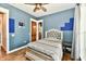 This home's bedroom features hardwood floors, new paint, and a ceiling fan at 1284 N Letterman Rd, Paragon, IN 46166