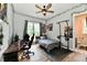 This bedroom features hardwood floors, new paint, ceiling fan, and an adjacent bathroom at 1284 N Letterman Rd, Paragon, IN 46166