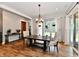 Bright dining room featuring wood floors, a chandelier, and sliding glass doors to the backyard at 1284 N Letterman Rd, Paragon, IN 46166