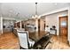 A well designed dining area, connecting kitchen and living space, with wood floors and a view of the backyard at 1284 N Letterman Rd, Paragon, IN 46166