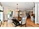 Well-lit dining area with wood floors, bench seating, and sliding doors to the backyard at 1284 N Letterman Rd, Paragon, IN 46166