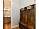 This home entryway features wood style floors, a wood bench and rack, and a view to the bathroom at 1284 N Letterman Rd, Paragon, IN 46166