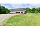 Picture of the home with a three car garage and brick exterior, set back on a sprawling lot at 1284 N Letterman Rd, Paragon, IN 46166