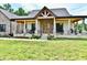 Covered porch with beautiful stone and brick accents, seating, and double-door entry at 1284 N Letterman Rd, Paragon, IN 46166