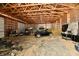 Interior view of the garage with a car, lawnmower, and other equipment at 1284 N Letterman Rd, Paragon, IN 46166