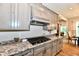 A modern kitchen with granite countertops, grey cabinets, and stainless steel appliances at 1284 N Letterman Rd, Paragon, IN 46166