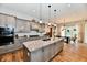 Bright kitchen with gray cabinets, granite countertops, and stainless appliances, adjacent to the dining room for easy serving at 1284 N Letterman Rd, Paragon, IN 46166