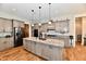 Stylish kitchen featuring stone counters, pendant lights, and stainless appliances, seamlessly blending with the living space at 1284 N Letterman Rd, Paragon, IN 46166