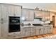 Gourmet kitchen with gray cabinetry, granite counters, and stainless steel appliances, perfect for culinary enthusiasts at 1284 N Letterman Rd, Paragon, IN 46166