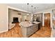 Gourmet kitchen with stone counters, pendant lights, and stainless appliances offers a seamless transition to the living room at 1284 N Letterman Rd, Paragon, IN 46166