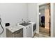 This laundry room features a new washer and dryer and adjacent cabinets for optimal convenience at 1284 N Letterman Rd, Paragon, IN 46166