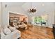 Bright living room with a vaulted ceiling, wood floors, and sliding doors to the patio, creating a seamless indoor-outdoor flow at 1284 N Letterman Rd, Paragon, IN 46166