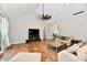 Cozy living room featuring hardwood floors, a stylish ceiling fan, and access to the inviting outdoor patio at 1284 N Letterman Rd, Paragon, IN 46166