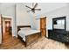 Main bedroom featuring wood floors, a ceiling fan, and a rustic barn door at 1284 N Letterman Rd, Paragon, IN 46166