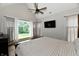 Main bedroom with wood floors, a ceiling fan, and large windows overlooking the backyard at 1284 N Letterman Rd, Paragon, IN 46166