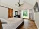 Spacious main bedroom with vaulted ceiling, wood floors, and a sliding barn door at 1284 N Letterman Rd, Paragon, IN 46166