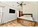 Light-filled main bedroom with wood floors and a ceiling fan at 1284 N Letterman Rd, Paragon, IN 46166