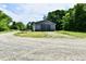 View of the gray outbuilding on a gravel lot at 1284 N Letterman Rd, Paragon, IN 46166