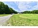 Spacious lot with a gravel driveway leading to a home surrounded by trees, offering privacy at 1284 N Letterman Rd, Paragon, IN 46166