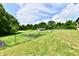 Scenic view of the property with an enclosed garden, a barn, and surrounding trees at 1284 N Letterman Rd, Paragon, IN 46166