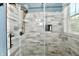 An updated bathroom shower with a glass door, new showerhead and tile at 1284 N Letterman Rd, Paragon, IN 46166