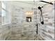 Close up on the light gray and white tiled shower with a black shower head and glass surround at 1284 N Letterman Rd, Paragon, IN 46166